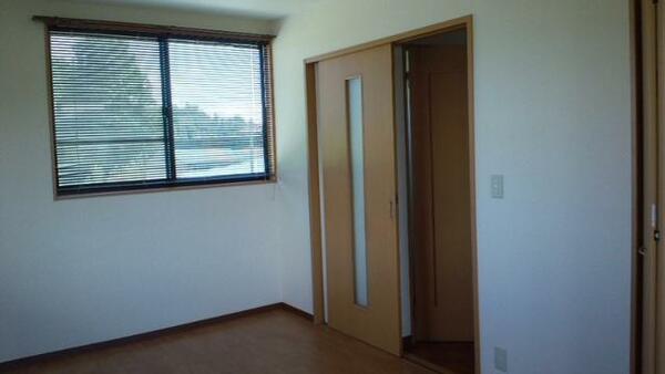 画像8:洋室から入口ドアを。窓から見えるのは東側の景色です。