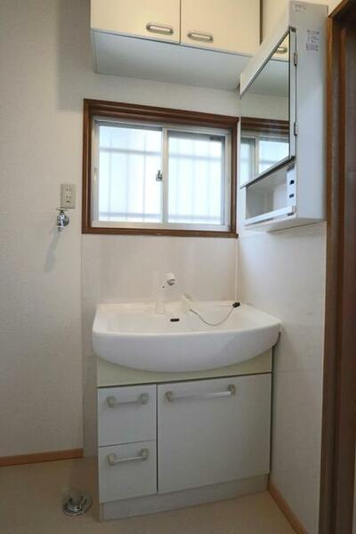 幅が広く使いやすいシャワー付き洗面台　左側には洗濯機を置いても余裕のスペースを確保