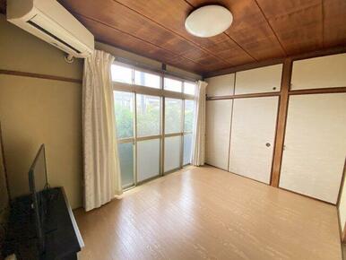 南向きの窓からたっぷりと光が差し込む、明るく心地よい洋室。天井や建具には趣のある木材を使用し、落ち着