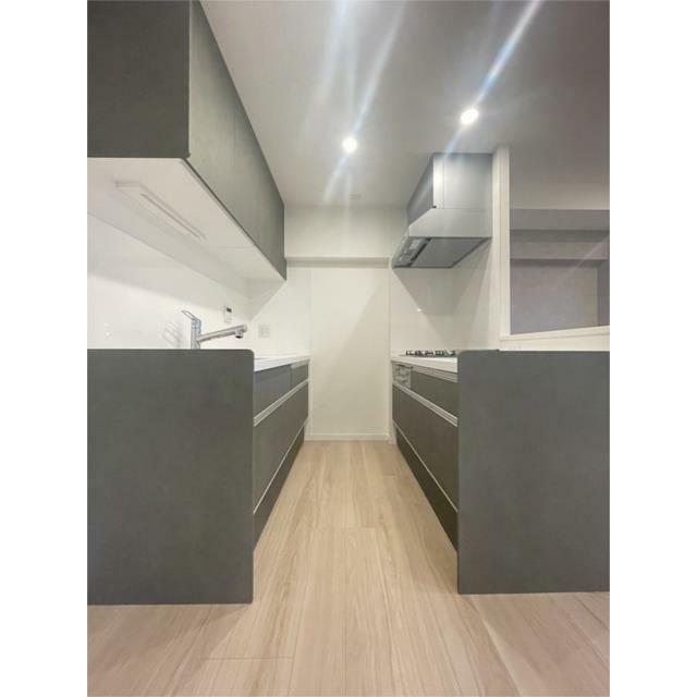 洗練されたダークグレーのキッチンは、スタイリッシュな空間を演出。明るい木目調のフロアが清潔感をプラス