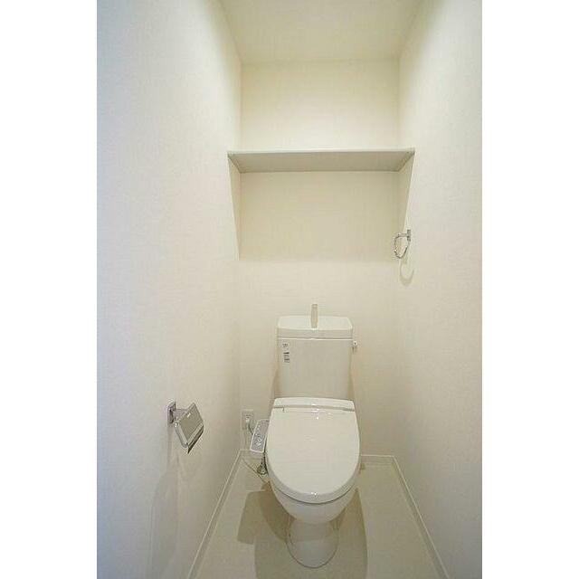 【トイレ】シャワー付きトイレ　トイレットペーパー等の収納に便利な棚付き。