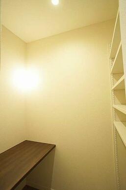 リビングにカウンターと作り付けの棚があります。在宅ワークや趣味のスペースとして活用できます。