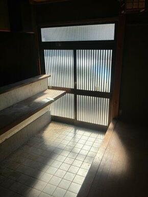 引き戸から自然光が差し込む店舗入口。土間仕様となっています